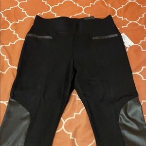 Luxe ponte legging with leather material on legs.